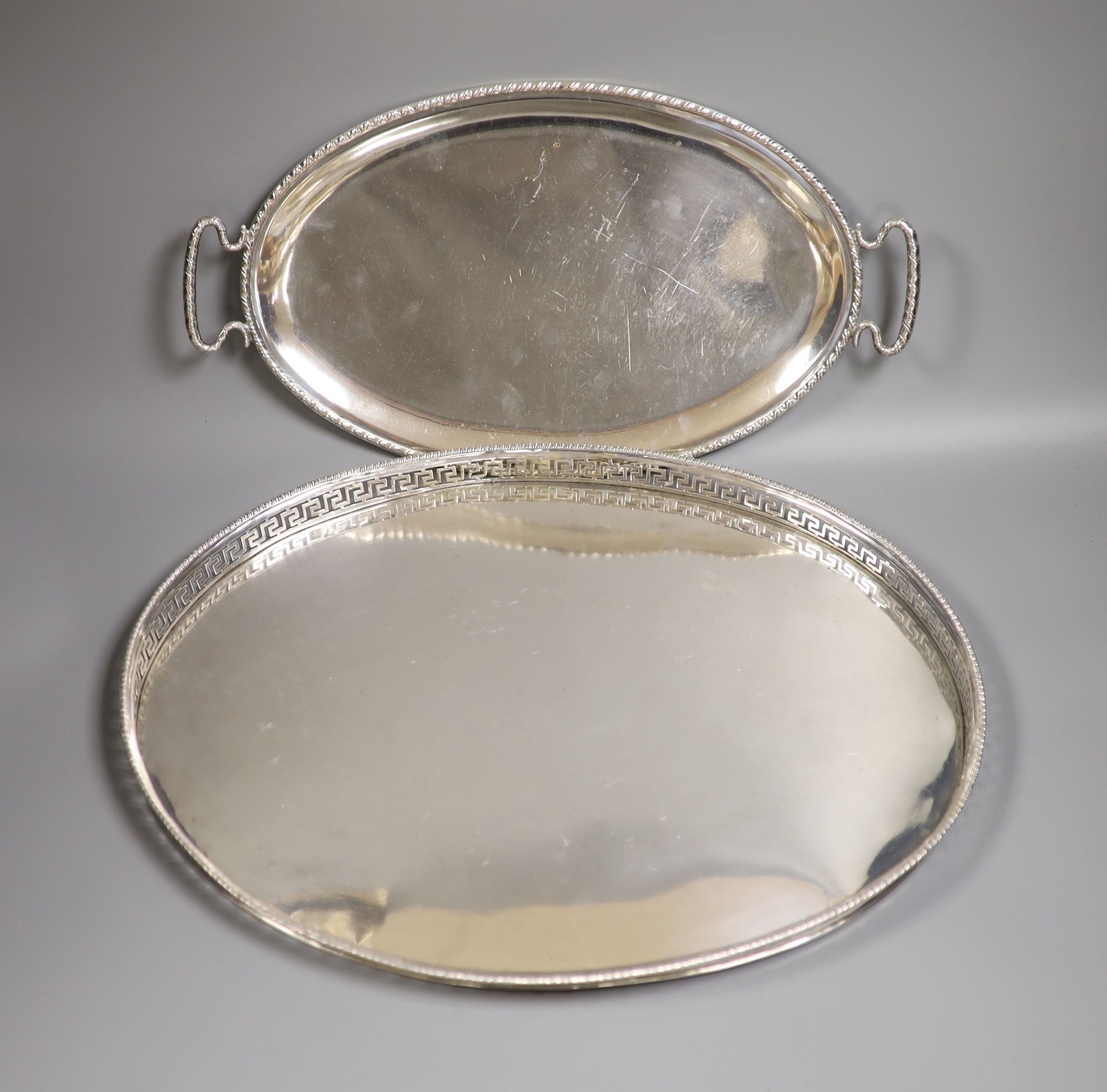 A late 19th century Hanau? embossed white metal oval dish, decorated with battle scene, 49cm, 24.5oz.